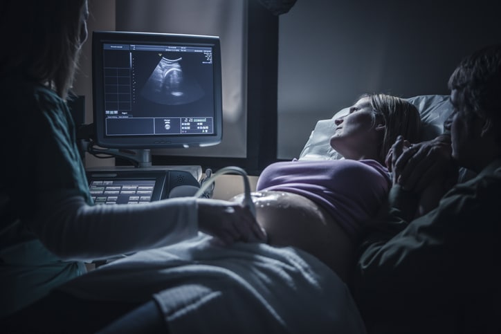 Pregnant couple having sonogram.