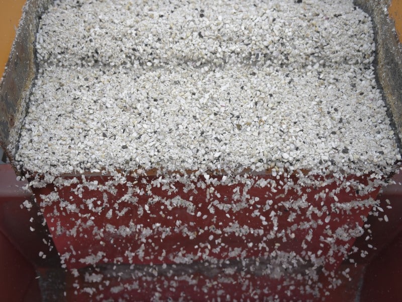 Lithium ore falls through a separation machine