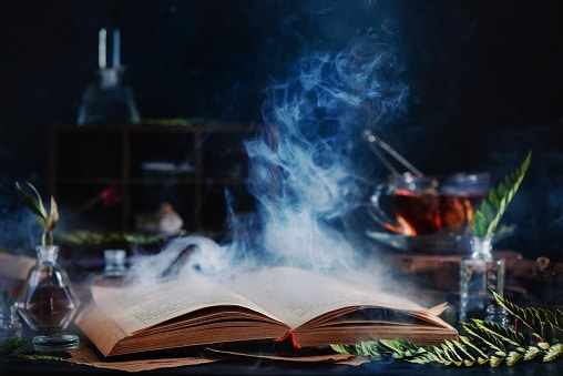 Haunted tales from the Prairies. Open spell book with magical smoke