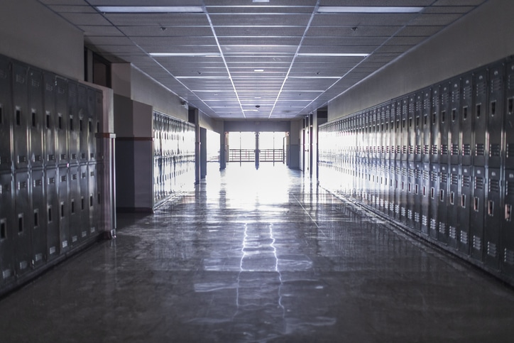 mpty high school corridor with lockers lining the walls